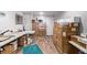 Spacious room with wood flooring and ample storage space featuring neatly stacked boxes and storage solutions at 1324 Shadow Mountain Dr, Highlands Ranch, CO 80126