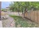 Backyard with gravel pathway, grass, and tree at 11275 Ranch Pl, Denver, CO 80234