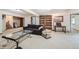 Finished basement with sitting area and built-in shelving at 11275 Ranch Pl, Denver, CO 80234