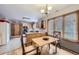 Bright dining area with wood table and chairs, adjacent to kitchen at 11275 Ranch Pl, Denver, CO 80234