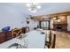 Bright dining room with hardwood floors, chandelier, and view of living room at 11275 Ranch Pl, Denver, CO 80234