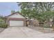 Front view of a brick ranch home with a two-car garage at 11275 Ranch Pl, Denver, CO 80234