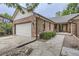 Brick home with a two-car garage and a walkway to the front entrance at 11275 Ranch Pl, Denver, CO 80234