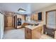 Galley kitchen with wood cabinets, granite countertops, and stainless steel appliances at 11275 Ranch Pl, Denver, CO 80234