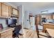 Kitchen features a built-in desk, wood cabinets, and hardwood floors at 11275 Ranch Pl, Denver, CO 80234