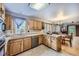 Spacious kitchen featuring wood cabinets, stainless steel appliances, and tile flooring at 11275 Ranch Pl, Denver, CO 80234