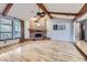 Living room with hardwood floors, fireplace and vaulted ceiling with wood beams at 11275 Ranch Pl, Denver, CO 80234