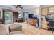 Hardwood floor living room with sectional sofa, ottoman, and built-in desk at 11275 Ranch Pl, Denver, CO 80234