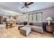 Living room with hardwood floors, sectional sofa and access to kitchen at 11275 Ranch Pl, Denver, CO 80234