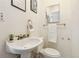Bathroom featuring a pedestal sink, mirror, and decorative wall art at 8060 Niwot Rd # 38, Niwot, CO 80503