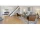 Open-concept living area with staircase, hardwood floors, and stylish decor at 8060 Niwot Rd # 38, Niwot, CO 80503