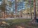 Spacious backyard with large trees and grassy area at 28735 Little Big Horn Dr, Evergreen, CO 80439