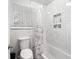 Clean bathroom with a shower/tub combo and updated tile at 28735 Little Big Horn Dr, Evergreen, CO 80439