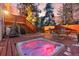 Deck featuring hot tub, dining set, grill, and stairs with a wooded backdrop at 28735 Little Big Horn Dr, Evergreen, CO 80439