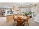 Kitchen with adjacent dining area and view into living room at 28735 Little Big Horn Dr, Evergreen, CO 80439