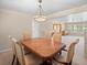 Dining room features a modern chandelier and an open floor plan to an additional living space at 28735 Little Big Horn Dr, Evergreen, CO 80439