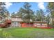Charming two-story home with a spacious deck, beautiful stonework, and set amongst mature trees at 28735 Little Big Horn Dr, Evergreen, CO 80439