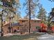 Back exterior view of home showcasing deck and yard at 28735 Little Big Horn Dr, Evergreen, CO 80439