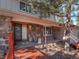 Charming home with a stone facade, a covered entryway, and a wood-plank deck at 28735 Little Big Horn Dr, Evergreen, CO 80439