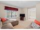 Gathering room with sectional sofa and built-in shelving at 28735 Little Big Horn Dr, Evergreen, CO 80439