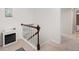 Hallway with wooden banister, carpet flooring, and an electric fireplace at 28735 Little Big Horn Dr, Evergreen, CO 80439