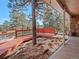 Wooden walkway leading to house entrance with tree and view at 28735 Little Big Horn Dr, Evergreen, CO 80439