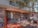 Inviting house entrance with stone facade and wooden walkway at 28735 Little Big Horn Dr, Evergreen, CO 80439