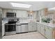 Spacious kitchen with stainless steel appliances and light cabinets at 28735 Little Big Horn Dr, Evergreen, CO 80439