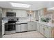 Well-lit kitchen with modern appliances, light-colored cabinetry, and a tile backsplash at 28735 Little Big Horn Dr, Evergreen, CO 80439