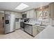 Spacious kitchen with stainless steel appliances and light cabinets at 28735 Little Big Horn Dr, Evergreen, CO 80439