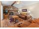 Cozy living room with stone fireplace and hardwood floors at 28735 Little Big Horn Dr, Evergreen, CO 80439