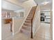 Carpeted staircase leading to the upper level, with the kitchen nearby at 28735 Little Big Horn Dr, Evergreen, CO 80439