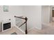 Upstairs hallway with a small electric fireplace and view of the staircase at 28735 Little Big Horn Dr, Evergreen, CO 80439