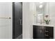 Modern bathroom with dark tile shower and a sleek vanity at 1217 E 26Th Ave, Denver, CO 80205