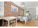 Bright dining area with a table for six and exposed brick wall at 1217 E 26Th Ave, Denver, CO 80205