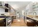 Open concept kitchen with stainless steel appliances and an exposed brick wall at 1217 E 26Th Ave, Denver, CO 80205