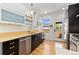 Updated kitchen featuring stainless steel appliances and light wood floors at 1217 E 26Th Ave, Denver, CO 80205