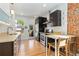 Modern kitchen with stainless steel appliances and an exposed brick wall at 1217 E 26Th Ave, Denver, CO 80205