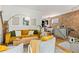 Bright living room with mustard yellow couch and two accent chairs at 1217 E 26Th Ave, Denver, CO 80205