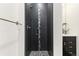 Modern shower with dark tile and pebble floor at 1217 E 26Th Ave, Denver, CO 80205