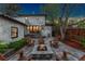 Backyard patio with fire pit provides a great spot for relaxation and entertaining under the evening sky at 1376 S Clayton St, Denver, CO 80210