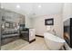 A spacious bathroom features a walk-in shower, a soaking tub, and modern fixtures at 1376 S Clayton St, Denver, CO 80210