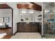 Bathroom boasts a double sink vanity, dark wood cabinets, and a glass-enclosed shower at 1376 S Clayton St, Denver, CO 80210