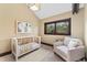 Cozy Bedroom with a crib, arm chair and natural light at 1376 S Clayton St, Denver, CO 80210
