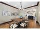 Traditional dining room showcasing dark wood trim and a glimpse into the kitchen at 1376 S Clayton St, Denver, CO 80210