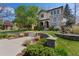 Charming stucco two-story home with stone accents and professionally landscaped front yard in a lush neighborhood at 1376 S Clayton St, Denver, CO 80210