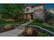 Charming two-story home featuring a stone and stucco facade, arched entryway, and well-manicured landscaping at 1376 S Clayton St, Denver, CO 80210