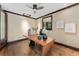 Bright home office featuring a modern desk, hardwood floors, and a window with natural light at 1376 S Clayton St, Denver, CO 80210