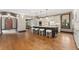 Open-concept kitchen with granite counters, an island with seating, and hardwood floors at 1376 S Clayton St, Denver, CO 80210