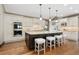 Spacious gourmet kitchen with an island and seating, modern stainless steel appliances, and hardwood floors at 1376 S Clayton St, Denver, CO 80210